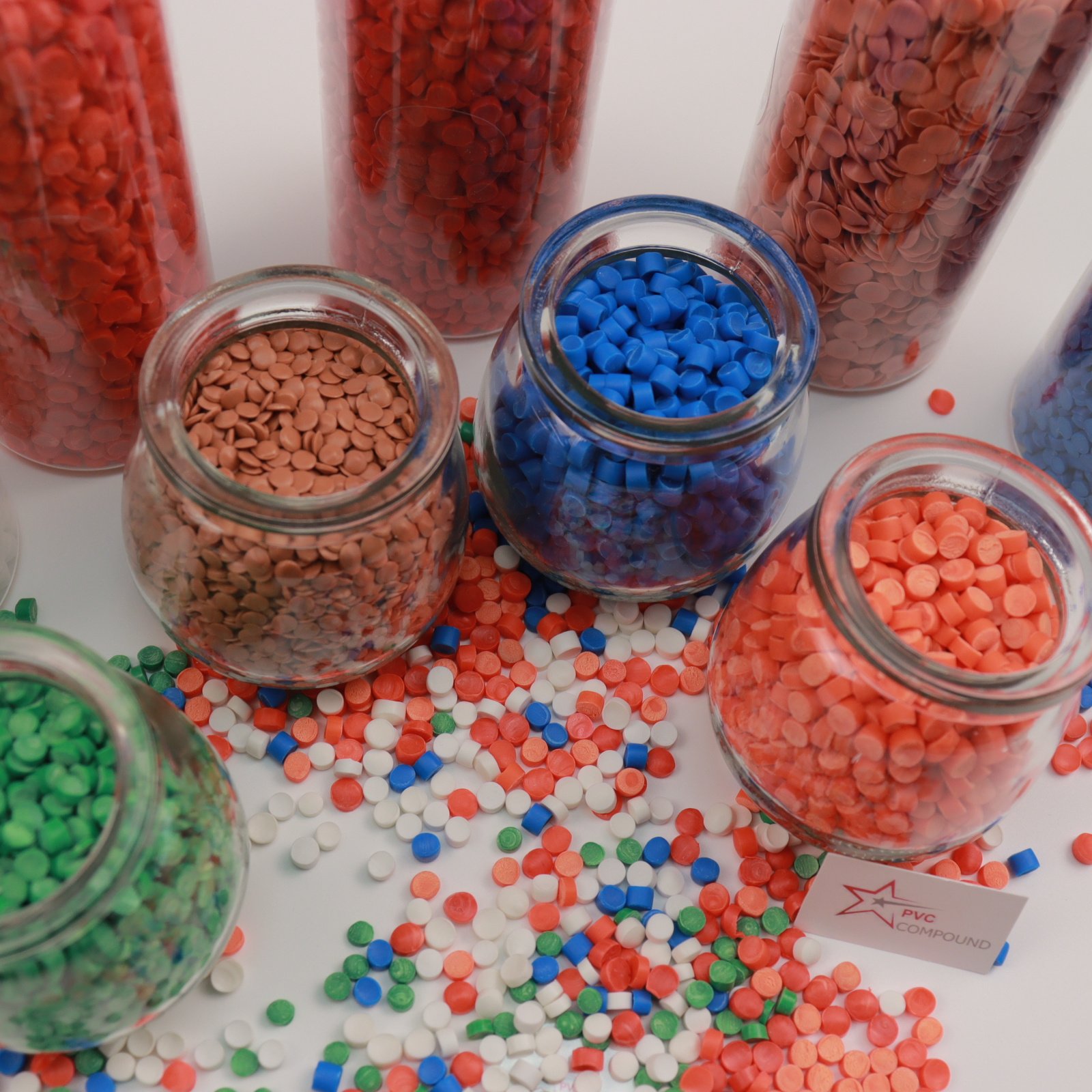 A close-up shot of various colorful PVC granules, showcasing the variety of formulations.
